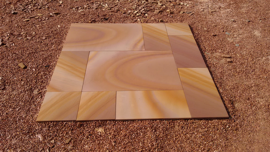 Set of stone tiles with a rippon pattern on a sandy background