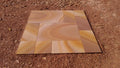 Set of stone tiles with a rippon pattern on a sandy background